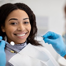 a patient smiling while visiting her Aetna dentist