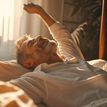 Mature man waking up after night of peaceful sleep