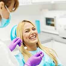 Laughing woman in dentist’s chair