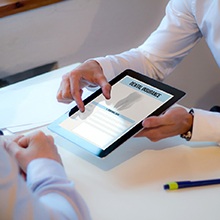 dental insurance on a tablet being shown to a patient