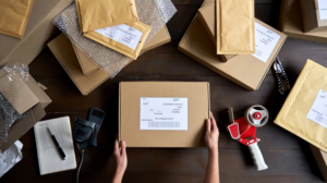 Top-down view of someone packaging up mail order clear aligners